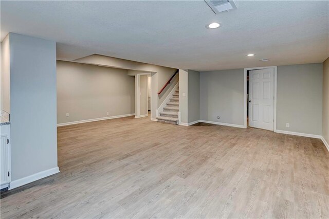 16253 W Briarwood Ct, Olathe, KS 66062 - finished basement featuring stairs, baseboards, recessed lighting, and light wood-style floors