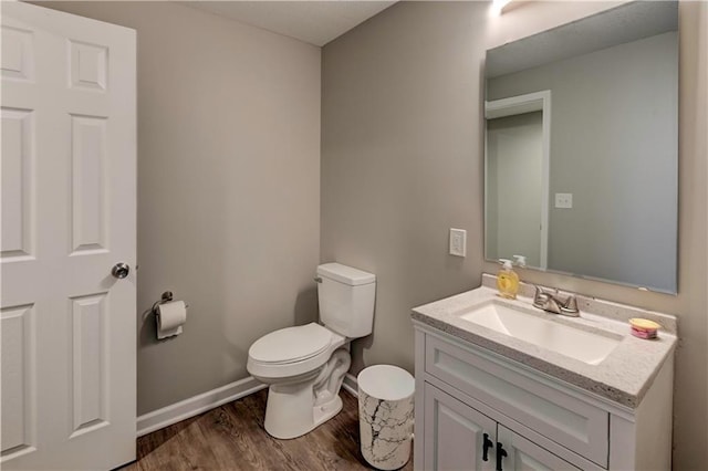 16253 W Briarwood Ct, Olathe, KS 66062 - half bathroom featuring wood finished floors, toilet, vanity, and baseboards