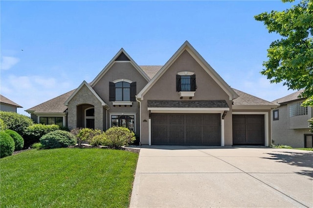 10233 N Prospect Ave, Kansas City, MO 64155 - french provincial home with driveway, a front yard, stucco siding, and a garage