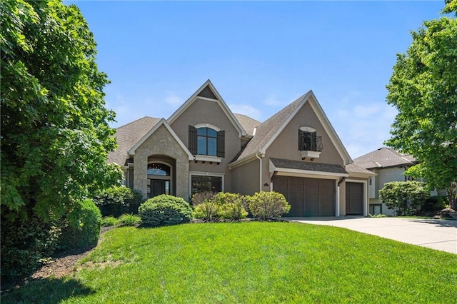 10233 N Prospect Ave, Kansas City, MO 64155 - view of front of home with stucco siding, a front yard, driveway, stone siding, and a garage