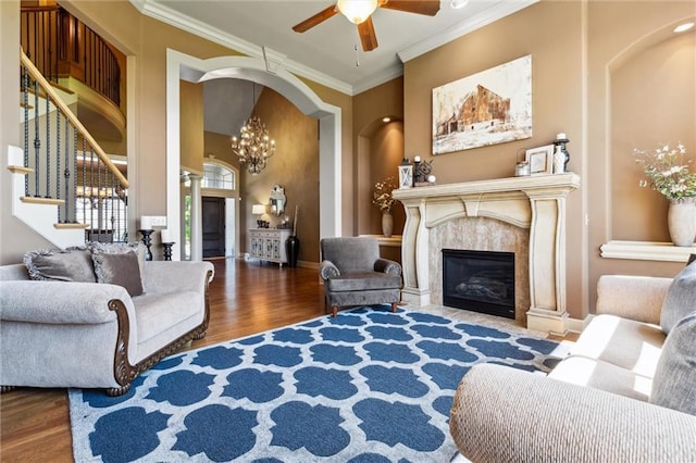 10233 N Prospect Ave, Kansas City, MO 64155 - living room with wood finished floors, ceiling fan, a chandelier, crown molding, and stairs