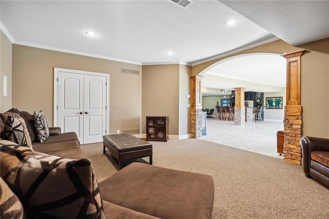 10233 N Prospect Ave, Kansas City, MO 64155 - living area featuring ornate columns, arched walkways, crown molding, carpet floors, and recessed lighting