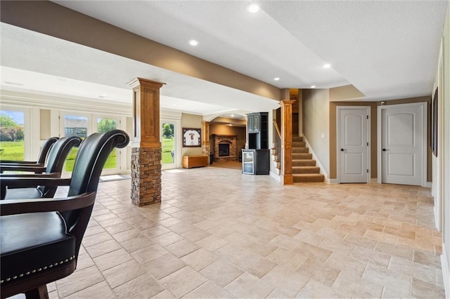 10233 N Prospect Ave, Kansas City, MO 64155 - below grade area featuring stone tile floors, baseboards, recessed lighting, stairway, and a stone fireplace