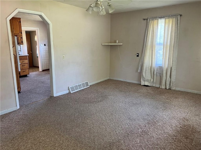 5720 NW 51st St, Kansas City, MO 64151 - spare room with carpet, arched walkways, and a ceiling fan