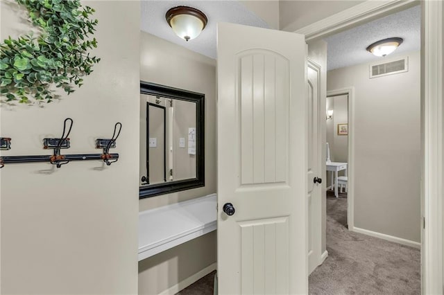 2002 NE 64th St, Gladstone, MO 64118 - hallway with carpet floors, a textured ceiling, and baseboards