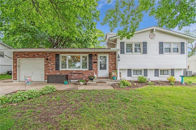2002 NE 64th St, Gladstone, MO 64118 - split level home featuring cooling unit, an attached garage, concrete driveway, a front lawn, and brick siding