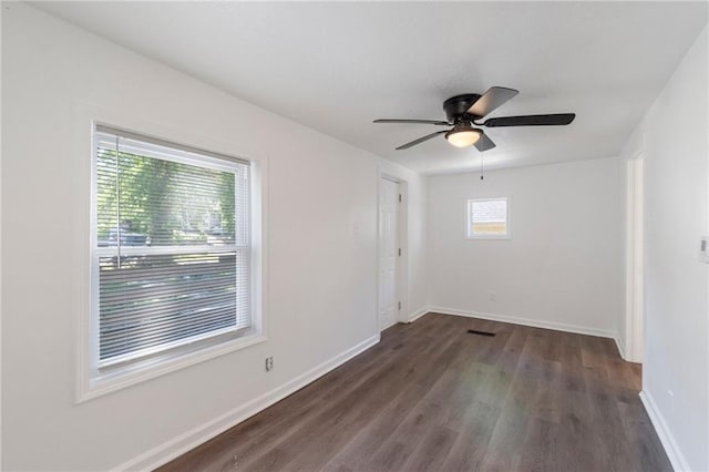 228 N 26th St, Kansas City, KS 66102 - empty room featuring dark wood finished floors, baseboards, and ceiling fan