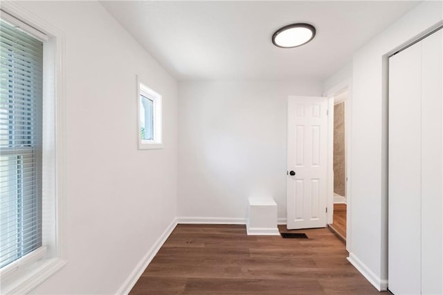 228 N 26th St, Kansas City, KS 66102 - unfurnished bedroom featuring dark wood-style flooring and baseboards