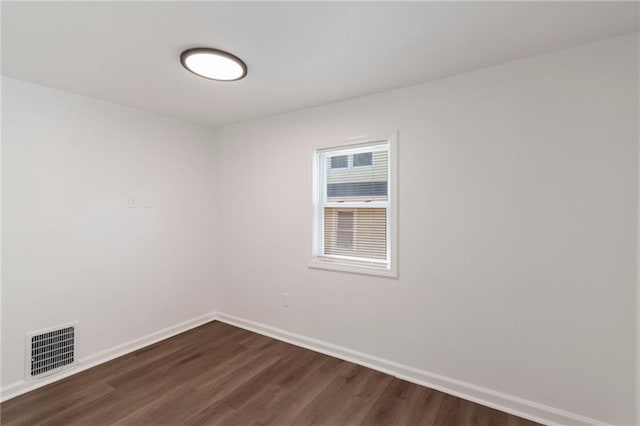 228 N 26th St, Kansas City, KS 66102 - empty room with dark wood-style floors and baseboards