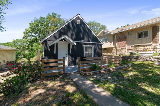 228 N 26th St, Kansas City, KS 66102 - view of front of house with fence and stone siding
