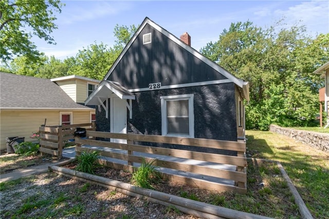 228 N 26th St, Kansas City, KS 66102 - view of front of home featuring fence and a chimney