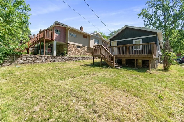 228 N 26th St, Kansas City, KS 66102 - back of house featuring stairway, a wooden deck, a lawn, and stone siding