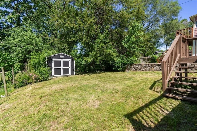 228 N 26th St, Kansas City, KS 66102 - view of grassy yard with a storage unit, stairs, an outbuilding, and a wooden deck
