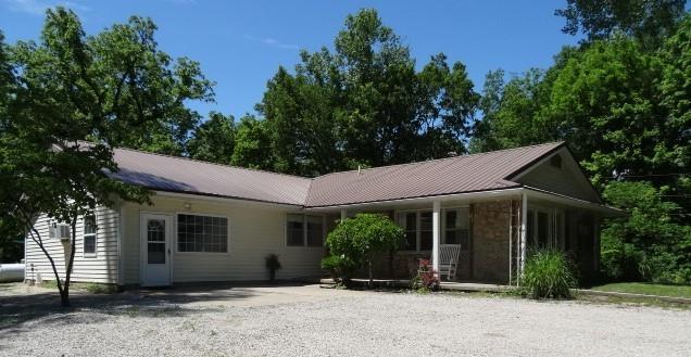 6780 SW County Road 2007th Rd, Rich Hill, MO 64779 - ranch-style home featuring a porch and metal roof