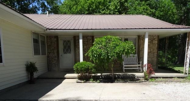 6780 SW County Road 2007th Rd, Rich Hill, MO 64779 - entrance to property with stone siding and metal roof