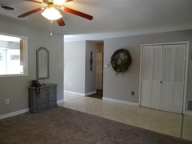 6780 SW County Road 2007th Rd, Rich Hill, MO 64779 - unfurnished living room with a ceiling fan and baseboards