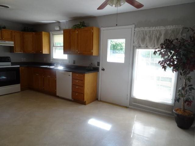6780 SW County Road 2007th Rd, Rich Hill, MO 64779 - kitchen with electric stove, dishwasher, under cabinet range hood, a ceiling fan, and brown cabinets