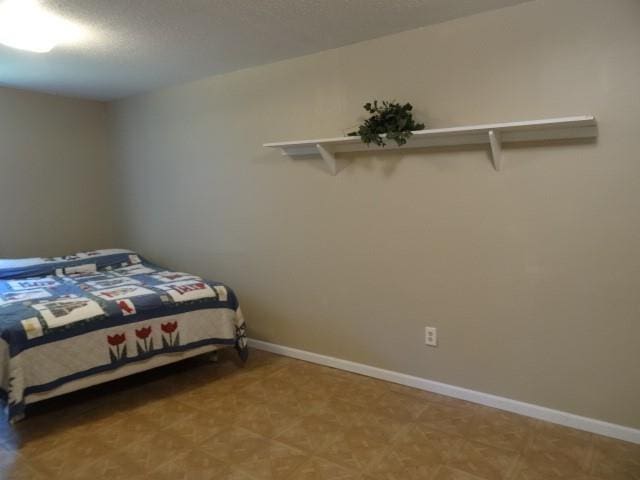 6780 SW County Road 2007th Rd, Rich Hill, MO 64779 - bedroom with baseboards and light floors