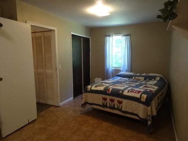 6780 SW County Road 2007th Rd, Rich Hill, MO 64779 - bedroom featuring multiple closets