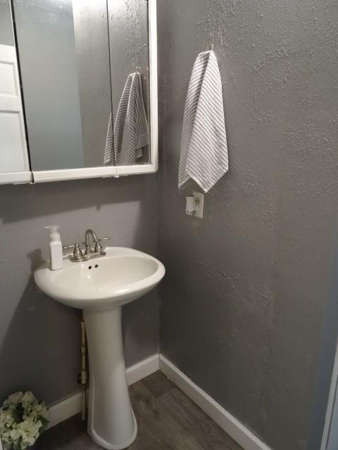 6780 SW County Road 2007th Rd, Rich Hill, MO 64779 - bathroom featuring wood finished floors and baseboards
