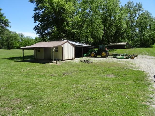 6780 SW County Road 2007th Rd, Rich Hill, MO 64779 - view of grassy yard with a pole building and an outdoor structure