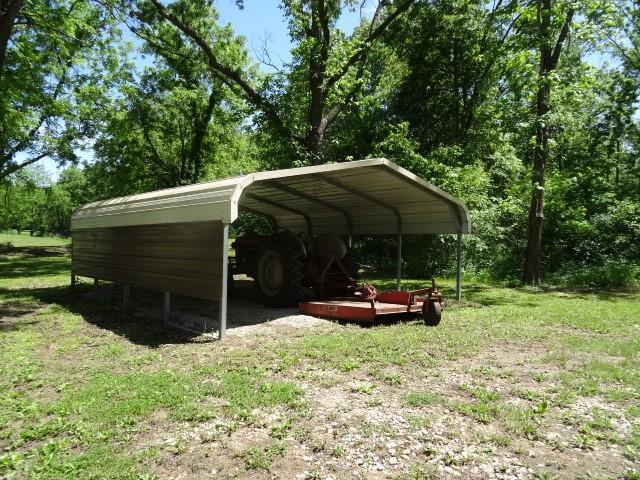 6780 SW County Road 2007th Rd, Rich Hill, MO 64779 - view of vehicle parking featuring a carport