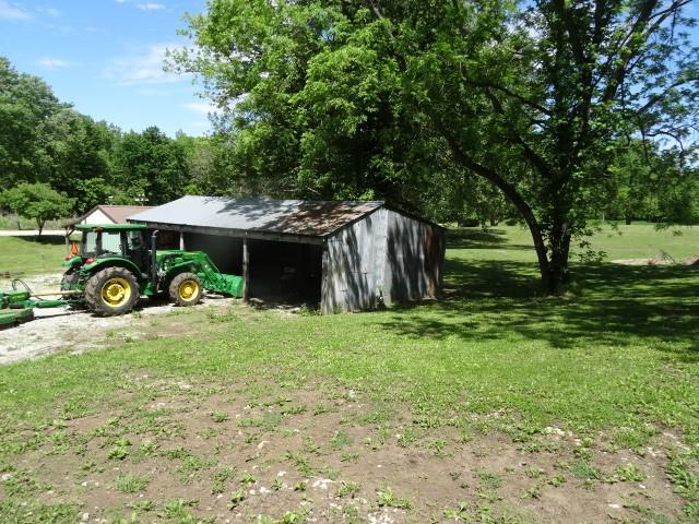 6780 SW County Road 2007th Rd, Rich Hill, MO 64779 - view of pole building featuring a yard
