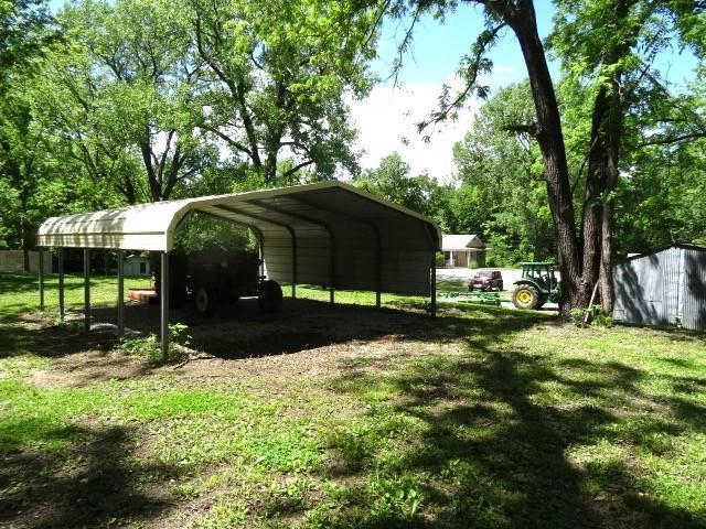 6780 SW County Road 2007th Rd, Rich Hill, MO 64779 - view of car parking featuring a detached carport