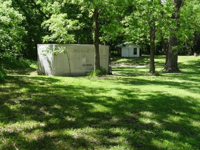 6780 SW County Road 2007th Rd, Rich Hill, MO 64779 - view of green lawn with an outbuilding and a shed
