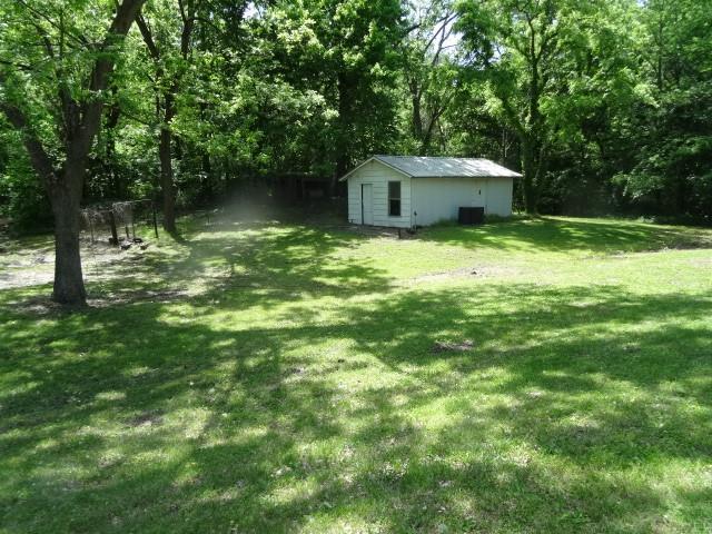 6780 SW County Road 2007th Rd, Rich Hill, MO 64779 - view of green lawn featuring an outdoor structure