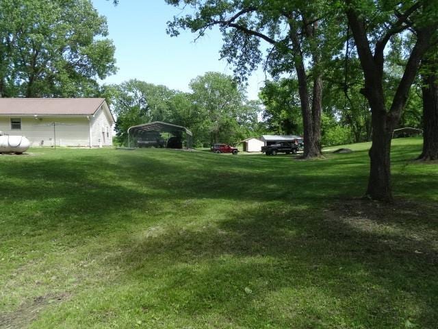 6780 SW County Road 2007th Rd, Rich Hill, MO 64779 - view of grassy yard with a carport