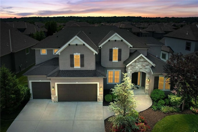 15601 Windsor St, Overland Park, KS 66224 - view of front of property with stone siding, stucco siding, concrete driveway, and roof with shingles