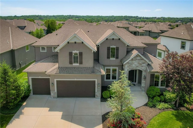 15601 Windsor St, Overland Park, KS 66224 - view of front facade with stone siding, stucco siding, roof with shingles, driveway, and an attached garage