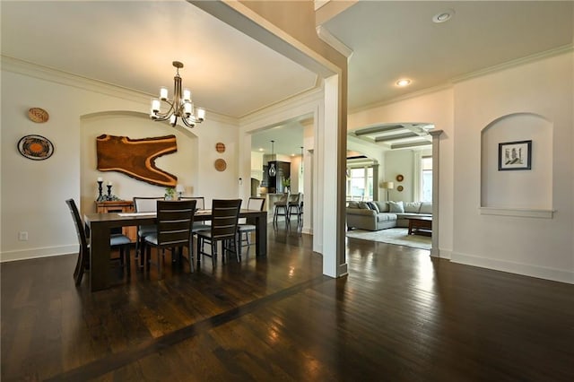 15601 Windsor St, Overland Park, KS 66224 - dining area with crown molding, arched walkways, wood finished floors, a chandelier, and baseboards