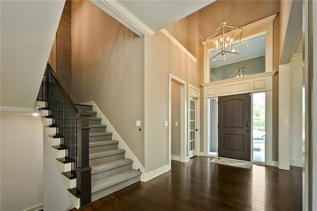 15601 Windsor St, Overland Park, KS 66224 - entryway featuring a high ceiling, a chandelier, stairs, dark wood finished floors, and baseboards