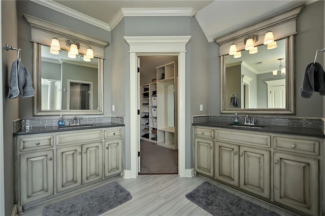 15601 Windsor St, Overland Park, KS 66224 - bathroom featuring tasteful backsplash, two vanities, wood finished floors, ornamental molding, and baseboards