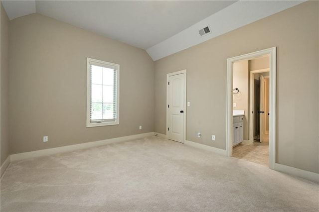 15601 Windsor St, Overland Park, KS 66224 - unfurnished bedroom featuring lofted ceiling, light carpet, baseboards, and connected bathroom