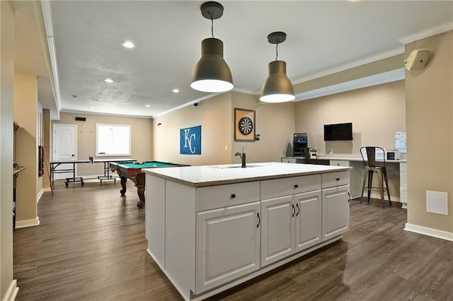 15601 Windsor St, Overland Park, KS 66224 - kitchen with light countertops, a kitchen island with sink, ornamental molding, white cabinets, and recessed lighting