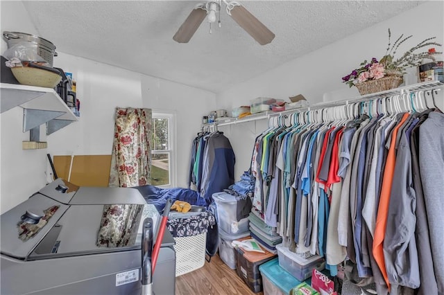 walk in closet featuring ceiling fan, vaulted ceiling, and wood finished floors