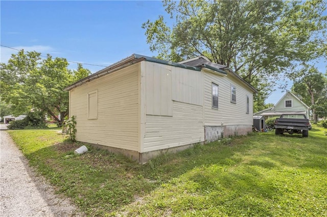 view of property exterior with a lawn