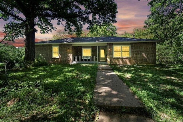 9405 Murphy Ln, Boonville, MO 65233 - single story home featuring brick siding, a front yard, and covered porch