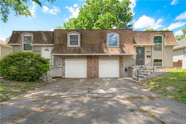 9406 Switzer St, Overland Park, KS 66214 - front facade with a shingled roof, mansard roof, asphalt driveway, and a garage