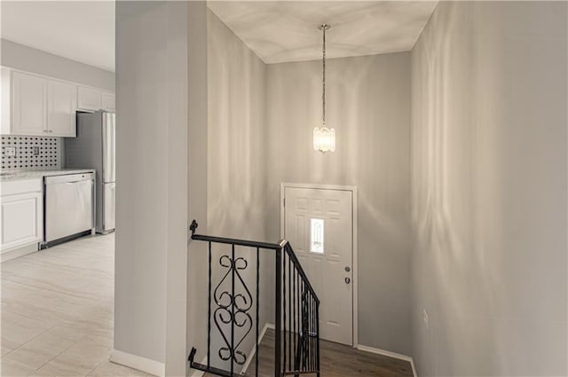9406 Switzer St, Overland Park, KS 66214 - stairway featuring a chandelier and baseboards