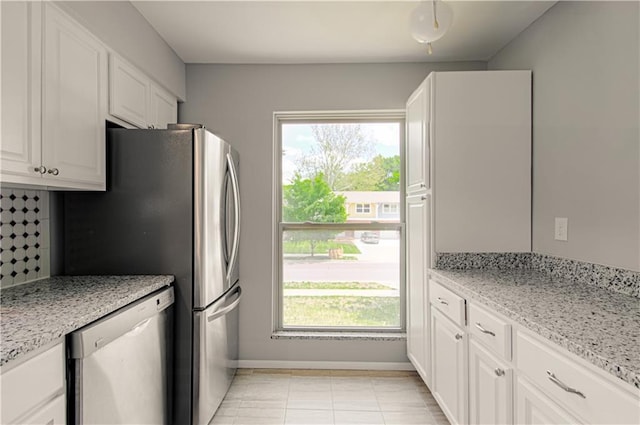 9406 Switzer St, Overland Park, KS 66214 - kitchen featuring dishwashing machine, healthy amount of natural light, and white cabinets