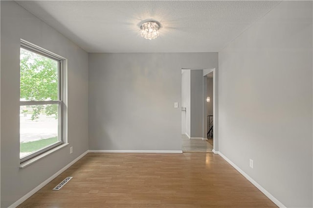 9406 Switzer St, Overland Park, KS 66214 - spare room with light wood finished floors, baseboards, and a chandelier