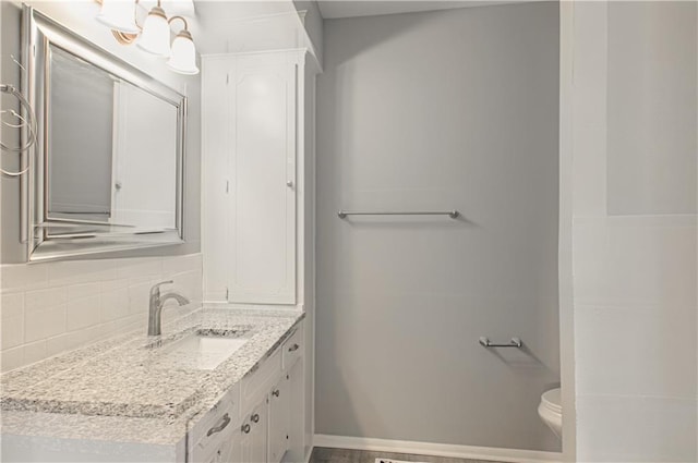 9406 Switzer St, Overland Park, KS 66214 - bathroom with tasteful backsplash, vanity, and toilet
