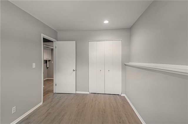 9406 Switzer St, Overland Park, KS 66214 - unfurnished bedroom with baseboards, wood finished floors, a closet, and recessed lighting