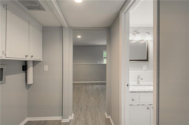 9406 Switzer St, Overland Park, KS 66214 - laundry room featuring cabinet space, light wood-style flooring, baseboards, recessed lighting, and hookup for a washing machine