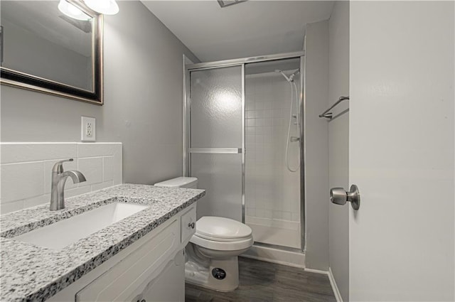 9406 Switzer St, Overland Park, KS 66214 - bathroom with a shower stall, wood finished floors, toilet, and vanity