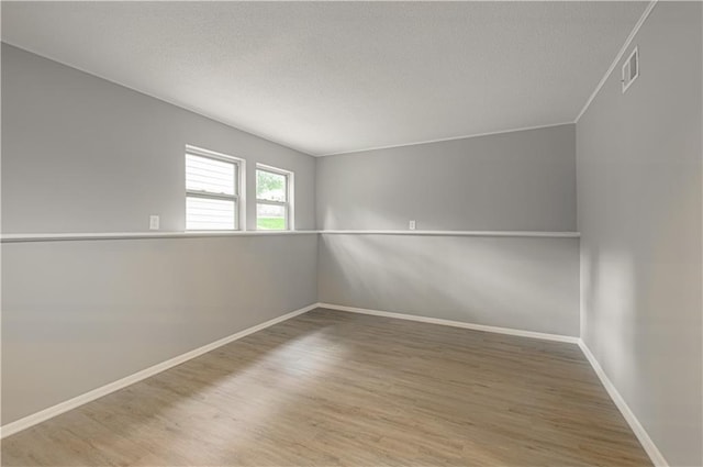 9406 Switzer St, Overland Park, KS 66214 - empty room with wood finished floors, a textured ceiling, and baseboards